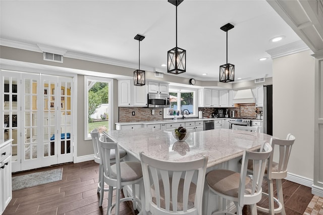 28 Lapin Ln, Blauvelt, NY 10913 - kitchen featuring stainless steel appliances, dark wood-style floors, white cabinetry, decorative backsplash, and crown molding