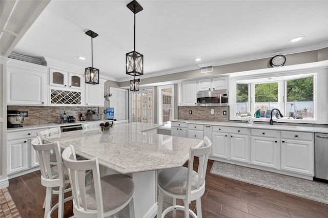 28 Lapin Ln, Blauvelt, NY 10913 - kitchen featuring stainless steel microwave, ornamental molding, recessed lighting, decorative backsplash, and a center island