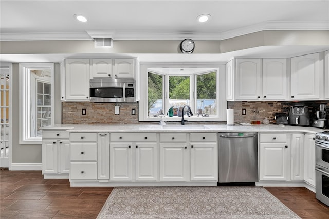 28 Lapin Ln, Blauvelt, NY 10913 - kitchen with stainless steel appliances, white cabinets, backsplash, ornamental molding, and recessed lighting