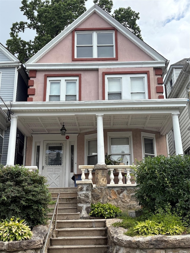 15 Grant St, Yonkers, NY 10704 - view of front of house featuring stucco siding and a porch