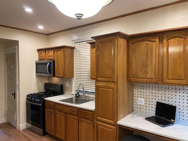 15 Grant St, Yonkers, NY 10704 - kitchen featuring stainless steel microwave, black range with gas cooktop, decorative backsplash, light countertops, and crown molding