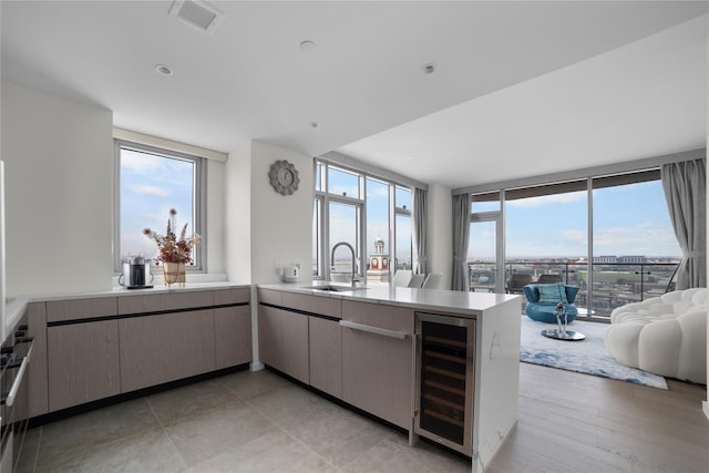 133-36 37th Ave Unit 10, Flushing, NY 11354 - kitchen with wine cooler, a peninsula, open floor plan, and light countertops