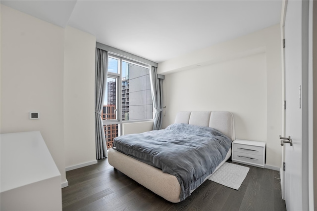133-36 37th Ave Unit 10, Flushing, NY 11354 - bedroom with baseboards and dark wood finished floors