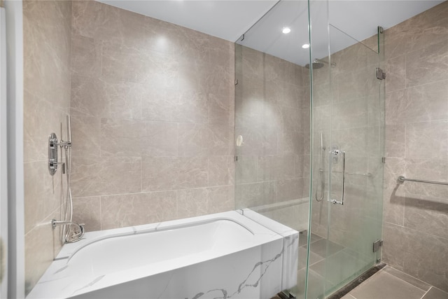 133-36 37th Ave Unit 10, Flushing, NY 11354 - bathroom featuring tile walls, a shower stall, a bath, recessed lighting, and tile patterned flooring