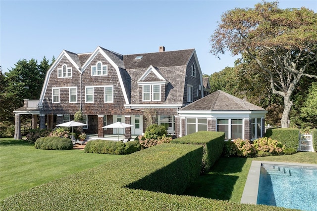 12120 New Suffolk Ave, Cutchogue, NY 11935 - rear view of house with a gambrel roof, a patio, a lawn, a chimney, and a shingled roof