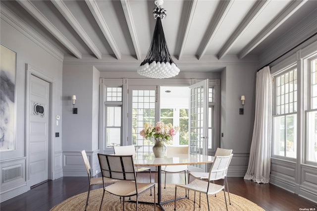 12120 New Suffolk Ave, Cutchogue, NY 11935 - dining area with dark wood finished floors, healthy amount of natural light, beam ceiling, a decorative wall, and crown molding