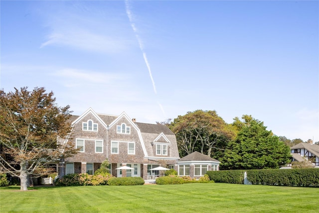 12120 New Suffolk Ave, Cutchogue, NY 11935 - shingle-style home with a gambrel roof, a front lawn, and a chimney