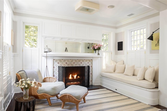 12120 New Suffolk Ave, Cutchogue, NY 11935 - living room featuring a decorative wall, a high end fireplace, ornamental molding, wood finished floors, and a wainscoted wall