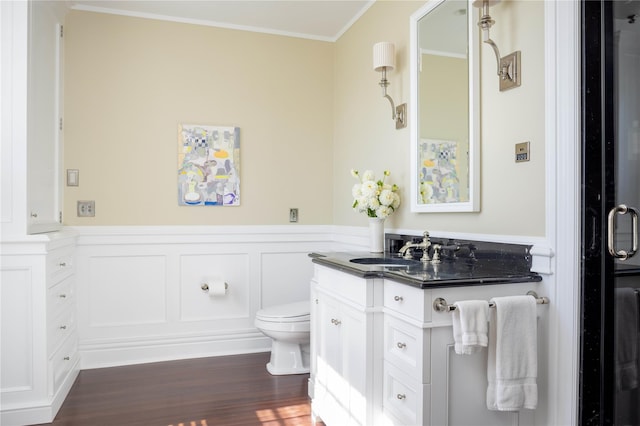 12120 New Suffolk Ave, Cutchogue, NY 11935 - bathroom featuring vanity, ornamental molding, a wainscoted wall, wood finished floors, and a decorative wall