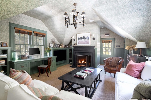 12120 New Suffolk Ave, Cutchogue, NY 11935 - living area featuring lofted ceiling, wainscoting, carpet flooring, a fireplace with flush hearth, and a chandelier