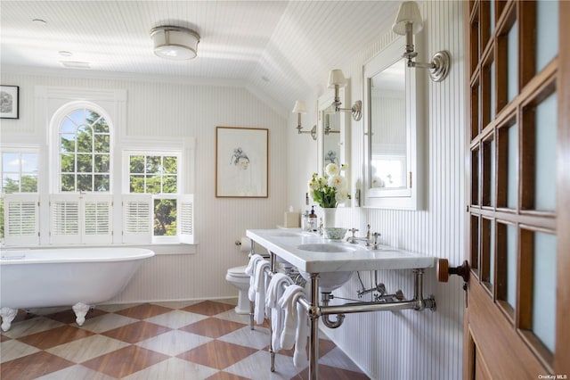 12120 New Suffolk Ave, Cutchogue, NY 11935 - full bathroom with a freestanding tub, lofted ceiling, and tile patterned floors
