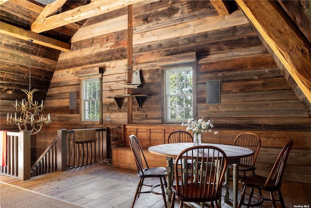 12120 New Suffolk Ave, Cutchogue, NY 11935 - dining room with wood walls, wood-type flooring, and a chandelier