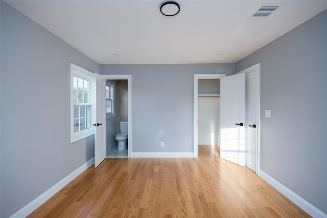 38 Bradford Ln, Bethpage, NY 11714 - unfurnished bedroom with light wood-style floors, a closet, and connected bathroom