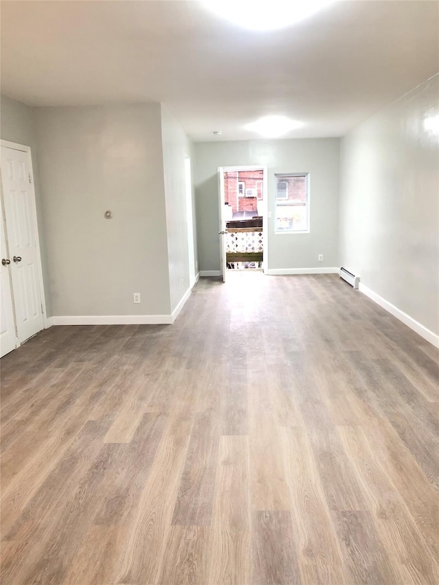 148-03 Horace Harding Expy, Flushing, NY 11367 - spare room featuring wood finished floors and baseboard heating