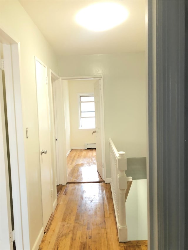 148-03 Horace Harding Expy, Flushing, NY 11367 - hallway with light wood finished floors, an upstairs landing, and a baseboard heating unit