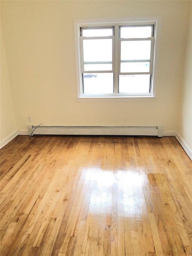 148-03 Horace Harding Expy, Flushing, NY 11367 - spare room with a baseboard radiator, healthy amount of natural light, and wood finished floors
