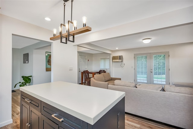 406 Red Maple Dr W, Wantagh, NY 11793 - kitchen with light wood-type flooring, a wall mounted AC, light countertops, pendant lighting, and recessed lighting