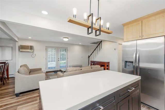 406 Red Maple Dr W, Wantagh, NY 11793 - kitchen featuring stainless steel refrigerator with ice dispenser, open floor plan, light wood-style flooring, light countertops, and a wall mounted air conditioner