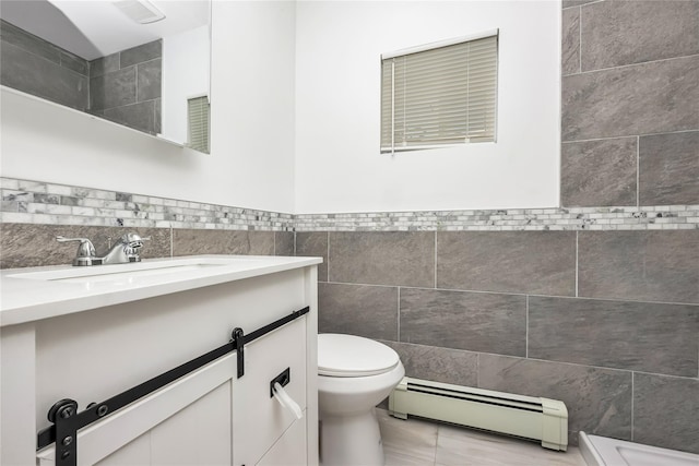 406 Red Maple Dr W, Wantagh, NY 11793 - bathroom with baseboard heating, tile walls, vanity, and a wainscoted wall