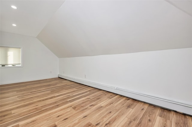 406 Red Maple Dr W, Wantagh, NY 11793 - bonus room with a baseboard heating unit, lofted ceiling, light wood-style floors, and recessed lighting