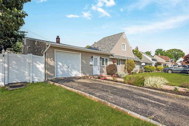 406 Red Maple Dr W, Wantagh, NY 11793 - view of front facade featuring a chimney, driveway, a garage, and a gate