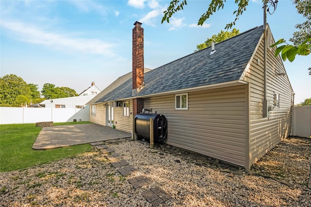 406 Red Maple Dr W, Wantagh, NY 11793 - rear view of house with heating fuel, a patio area, roof with shingles, and a chimney