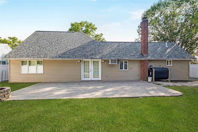 406 Red Maple Dr W, Wantagh, NY 11793 - rear view of house featuring oil tank, french doors, a chimney, roof with shingles, and a patio