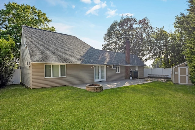 406 Red Maple Dr W, Wantagh, NY 11793 - rear view of house featuring french doors, a storage unit, a chimney, a patio area, and a fenced backyard
