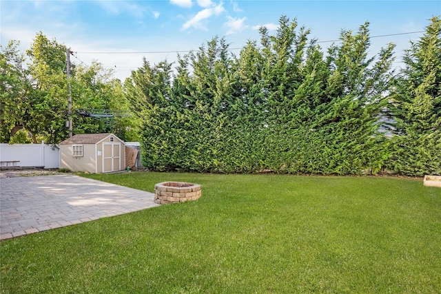 406 Red Maple Dr W, Wantagh, NY 11793 - fenced backyard with a fire pit, a storage unit, and a patio area