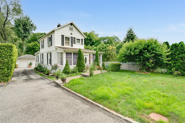 110 Pine Ave, Ossining, NY 10562 - view of front of property featuring an outbuilding, a detached garage, and a chimney