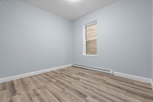 123 Elm St, Yonkers, NY 10701 - empty room with a baseboard radiator and light wood-style flooring
