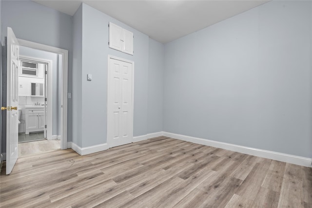 123 Elm St, Yonkers, NY 10701 - unfurnished bedroom featuring light wood-style floors and a closet