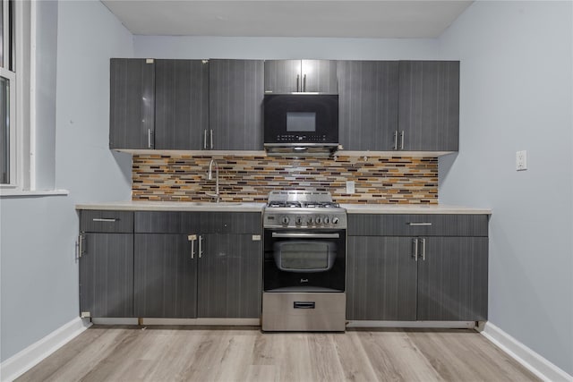 123 Elm St, Yonkers, NY 10701 - kitchen featuring stainless steel gas range, black microwave, light wood finished floors, light countertops, and gray cabinetry