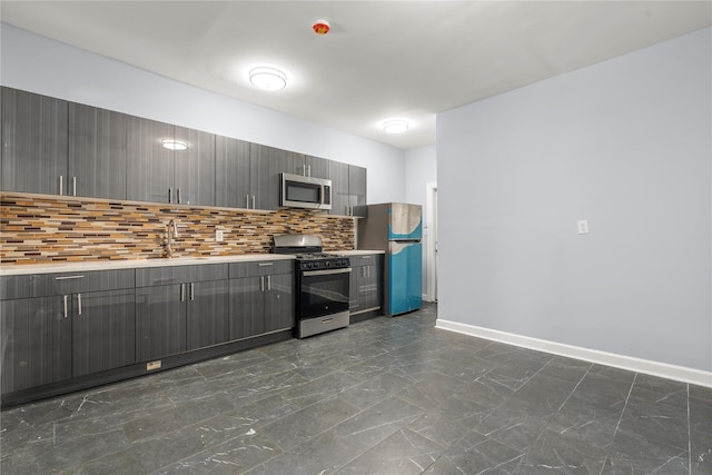 123 Elm St, Yonkers, NY 10701 - kitchen with stainless steel appliances, gray cabinets, decorative backsplash, and light countertops