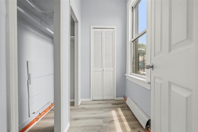 123 Elm St, Yonkers, NY 10701 - hall featuring baseboard heating, light wood-style flooring, and healthy amount of natural light