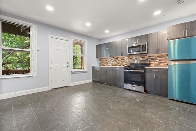123 Elm St, Yonkers, NY 10701 - kitchen featuring appliances with stainless steel finishes, dark marble finish floors, tasteful backsplash, recessed lighting, and light countertops