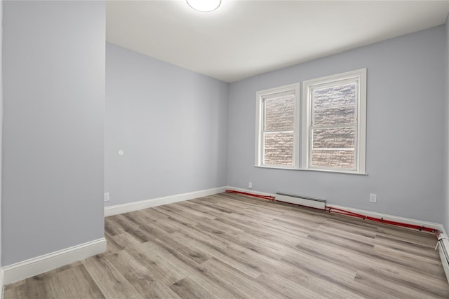 123 Elm St, Yonkers, NY 10701 - spare room featuring a baseboard heating unit, wood finished floors, and a baseboard radiator