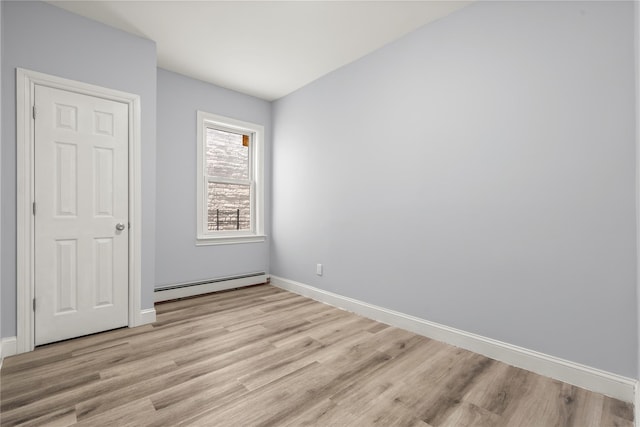 123 Elm St, Yonkers, NY 10701 - unfurnished bedroom featuring baseboard heating and light wood-style flooring