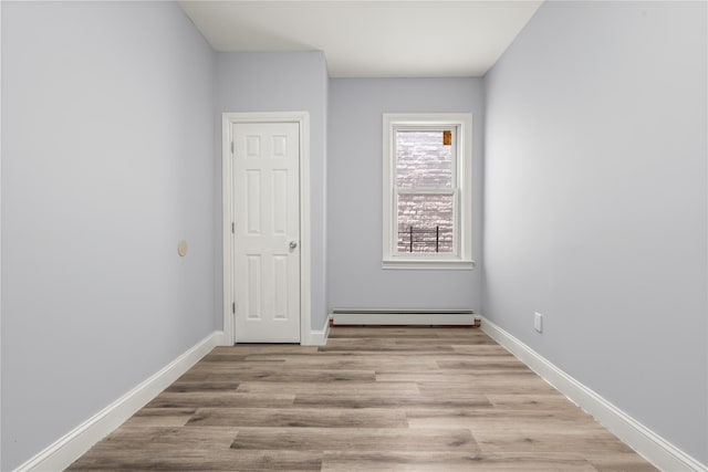 123 Elm St, Yonkers, NY 10701 - unfurnished room featuring a baseboard heating unit and wood finished floors