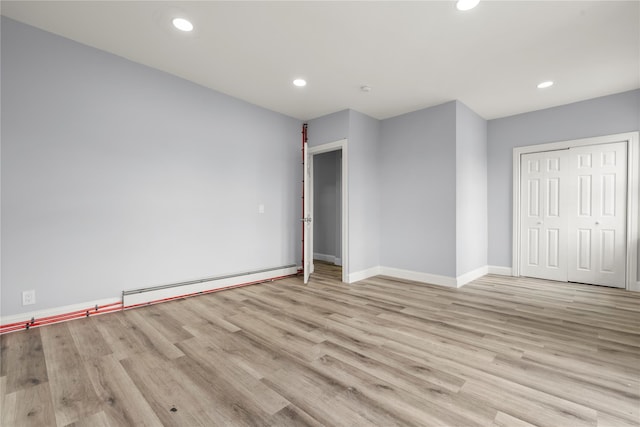 123 Elm St, Yonkers, NY 10701 - unfurnished bedroom featuring a baseboard radiator, wood finished floors, recessed lighting, and a closet