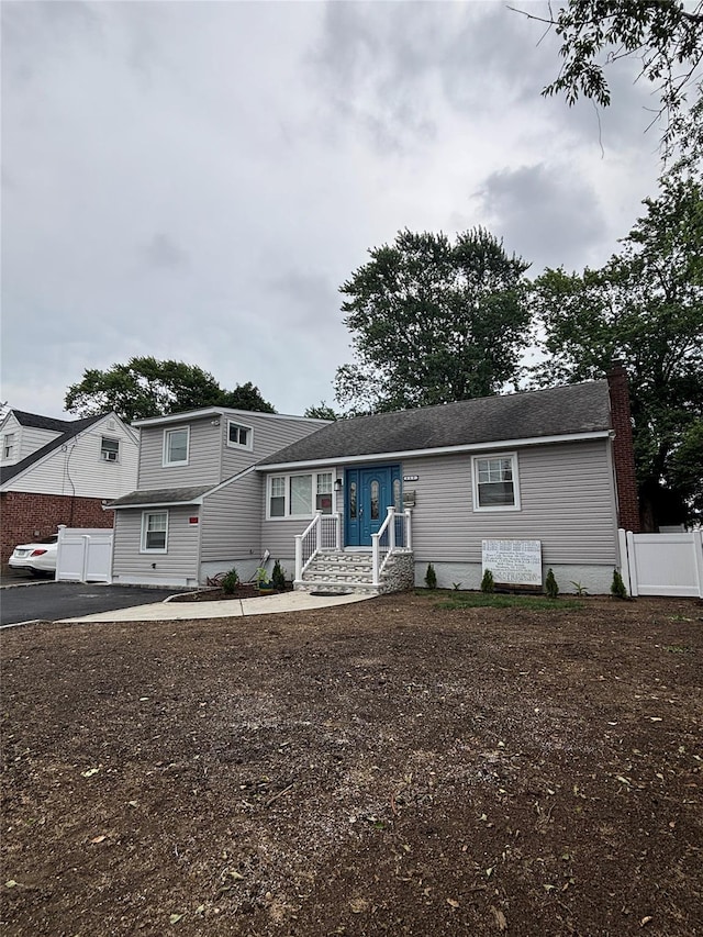 868 Oliver Ave, Westbury, NY 11590 - view of front of house with a chimney