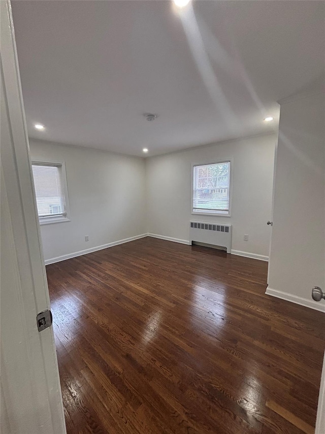 868 Oliver Ave, Westbury, NY 11590 - spare room featuring radiator heating unit, dark wood-style floors, and recessed lighting