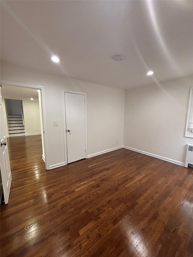 868 Oliver Ave, Westbury, NY 11590 - empty room with stairway, a smoke detector, dark wood finished floors, and recessed lighting