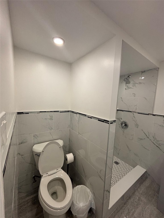 868 Oliver Ave, Westbury, NY 11590 - bathroom featuring tile walls, tiled shower, and wainscoting