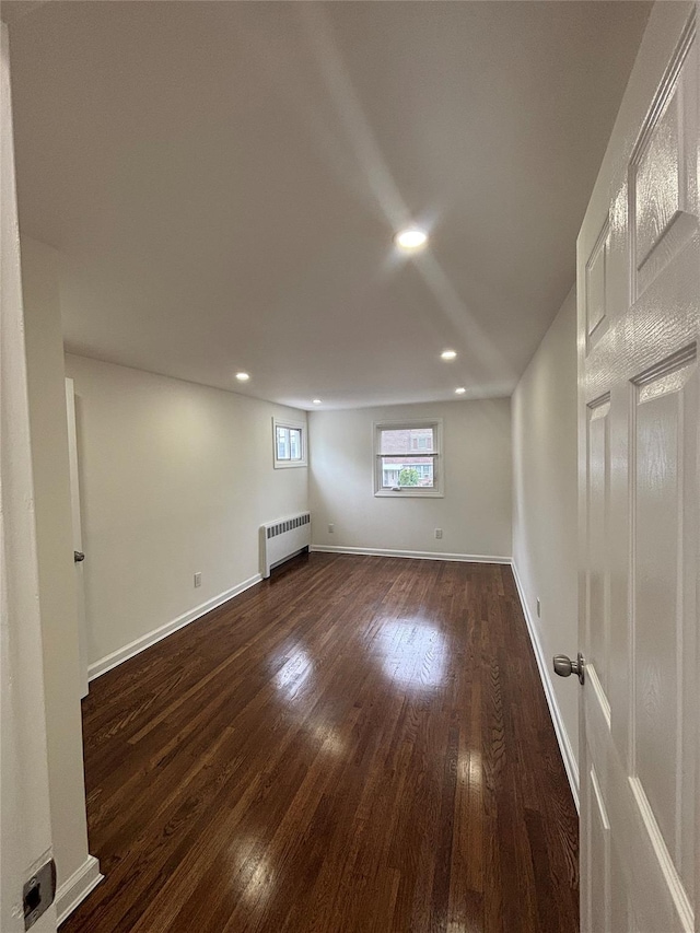 868 Oliver Ave, Westbury, NY 11590 - spare room with radiator heating unit, dark wood-style flooring, and recessed lighting