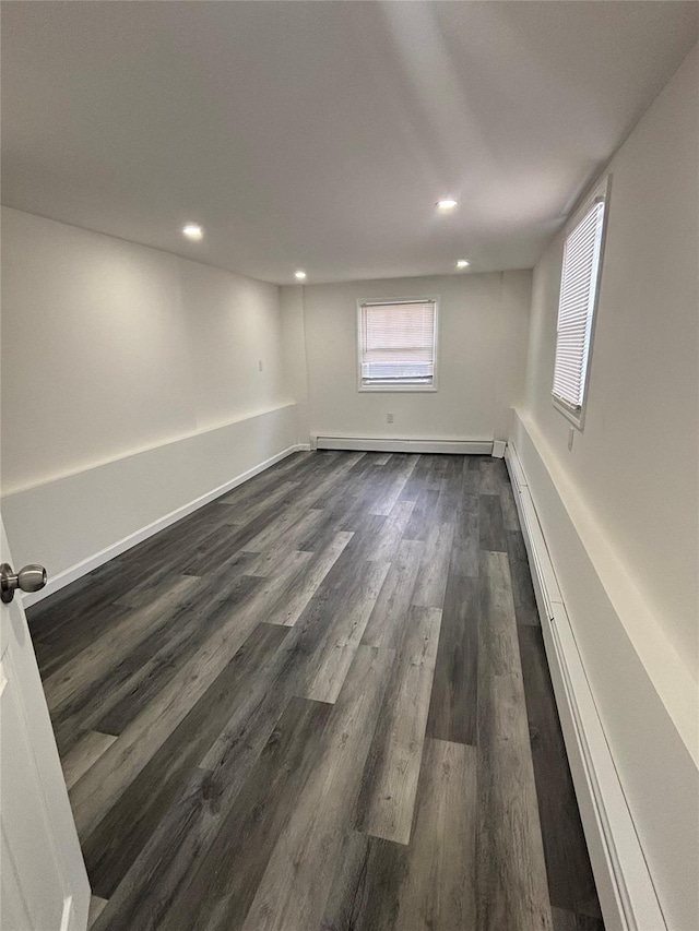 868 Oliver Ave, Westbury, NY 11590 - spare room with dark wood-type flooring, a baseboard heating unit, and recessed lighting