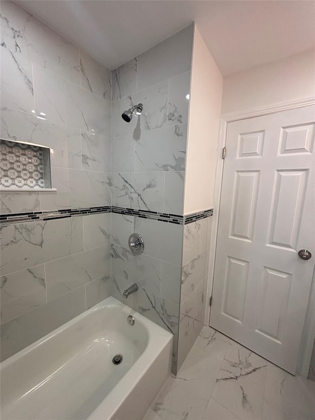 868 Oliver Ave, Westbury, NY 11590 - bathroom with bathtub / shower combination and marble look tile flooring