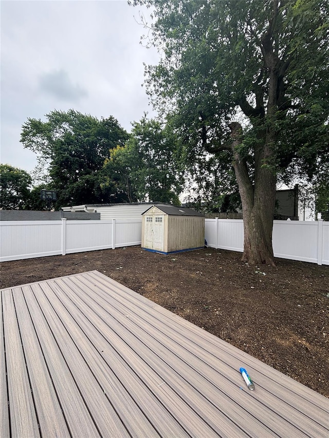 868 Oliver Ave, Westbury, NY 11590 - wooden terrace with a fenced backyard and a storage shed