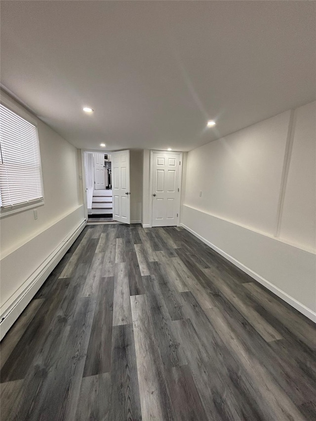868 Oliver Ave, Westbury, NY 11590 - unfurnished living room with stairway, recessed lighting, dark wood-style flooring, and a baseboard heating unit