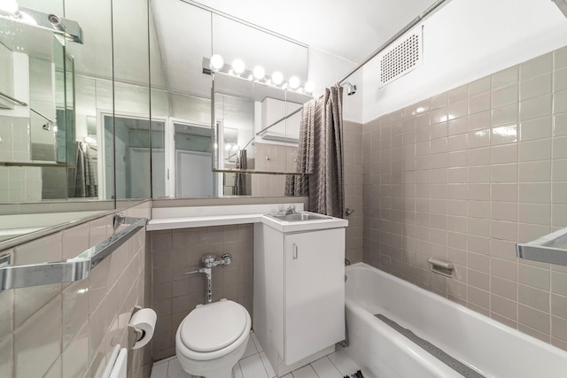 337 E 50th St Unit 3-A, New York Manhattan, NY 10022 - full bathroom featuring tile patterned flooring, tile walls, shower / bath combo with shower curtain, and vanity